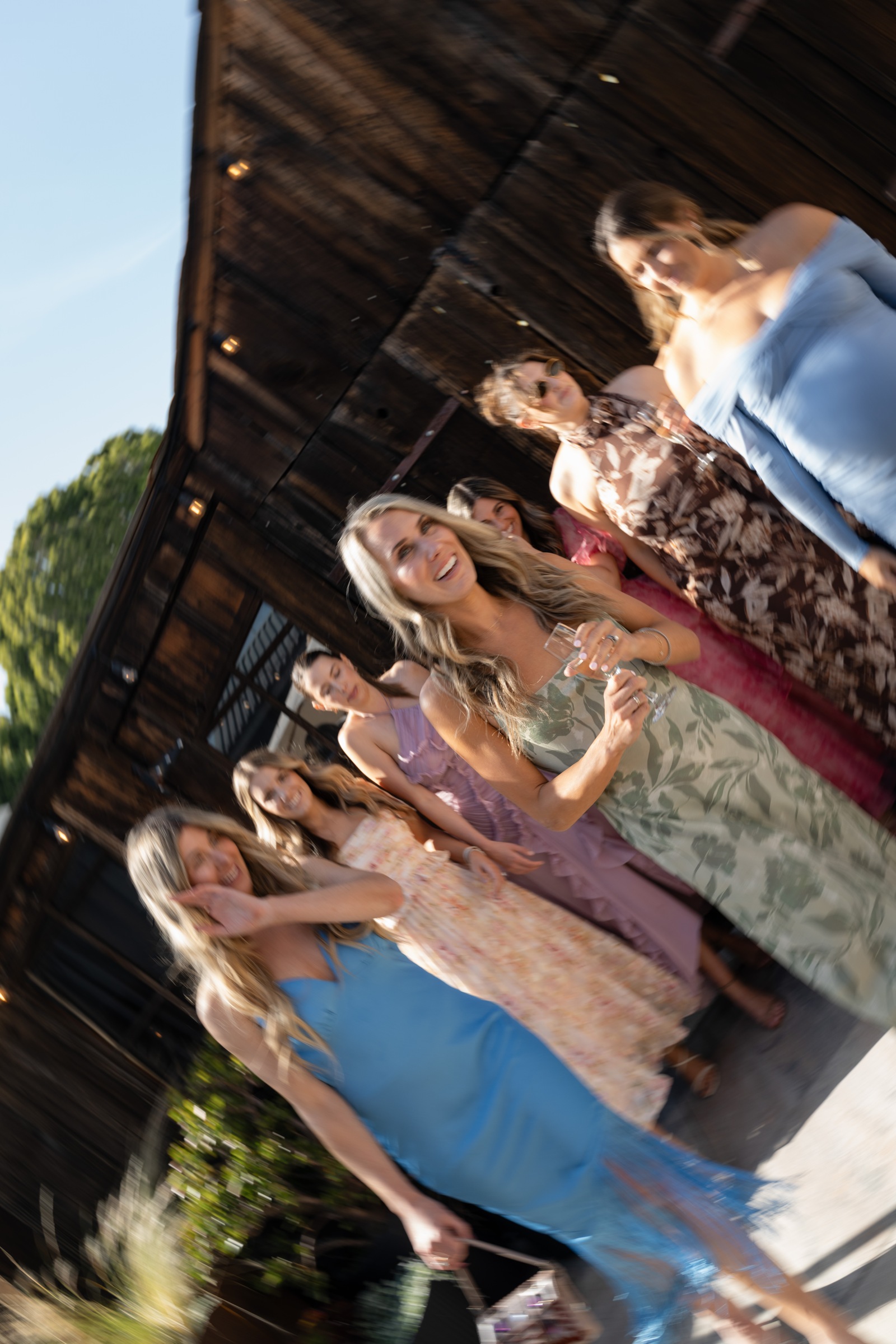 Wedding guests celebrating in colorful dresses