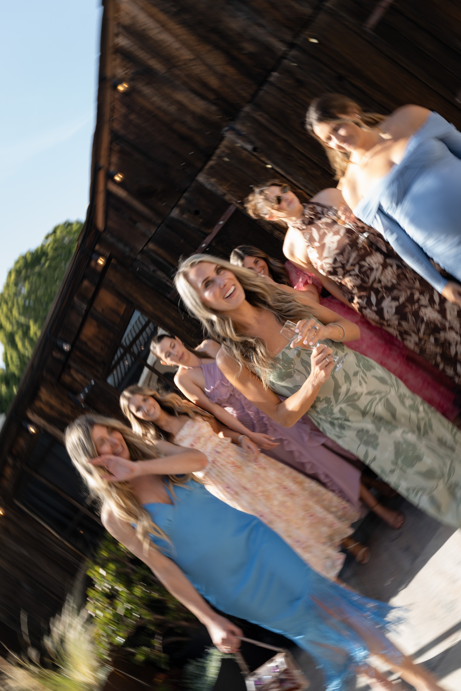 Wedding guests celebrating together in the afternoon sunshine