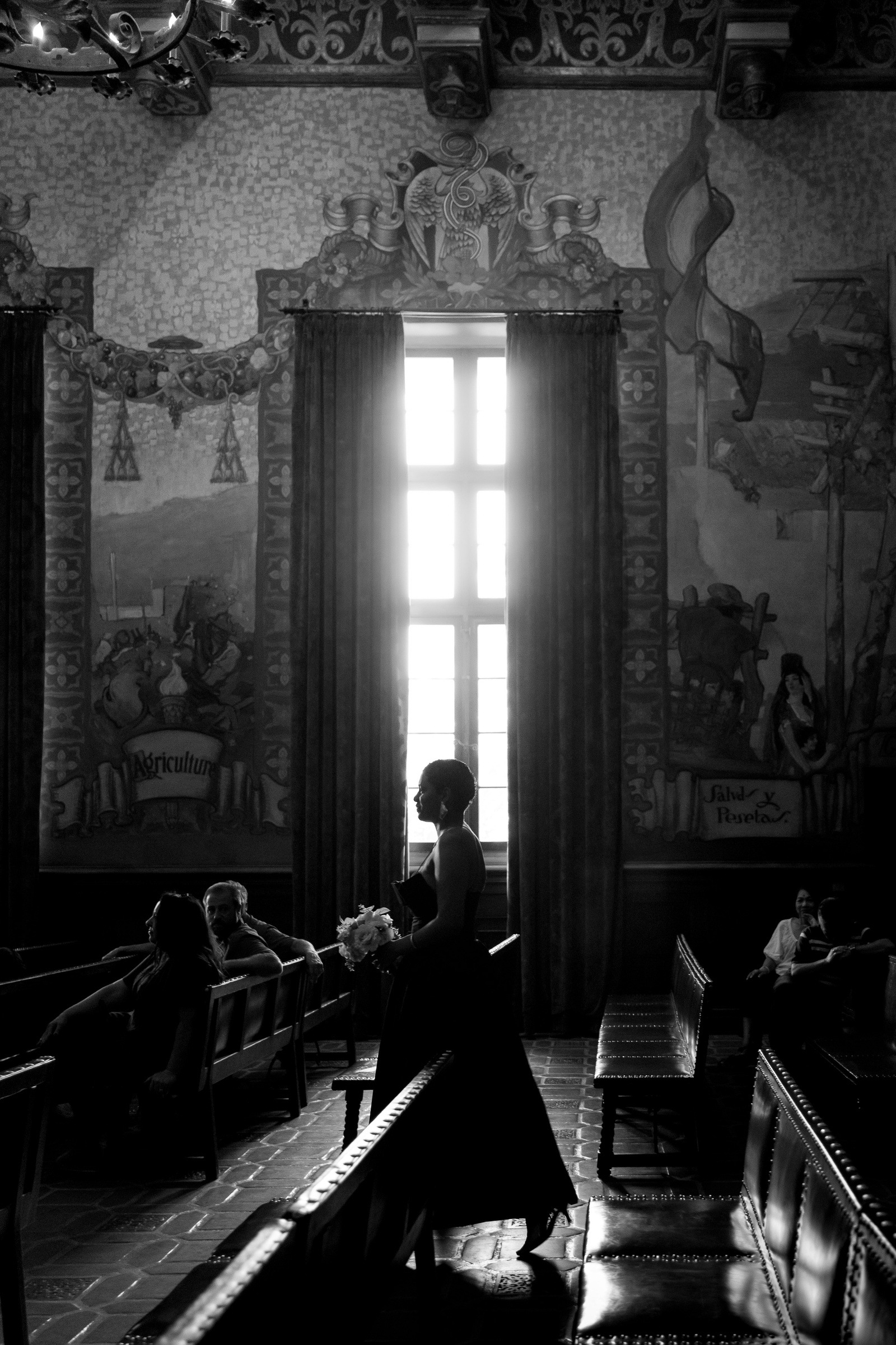 A bridesmaid walking through the mural room