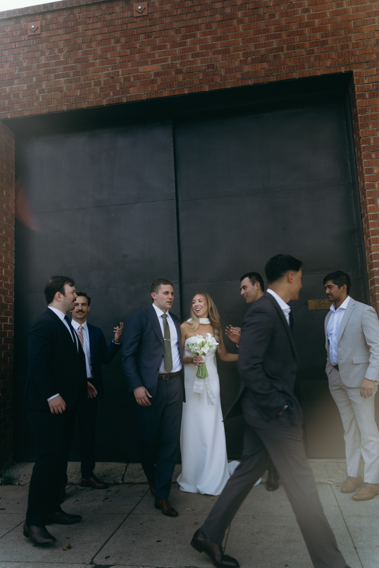 The newlyweds celebrating with their groomsmen