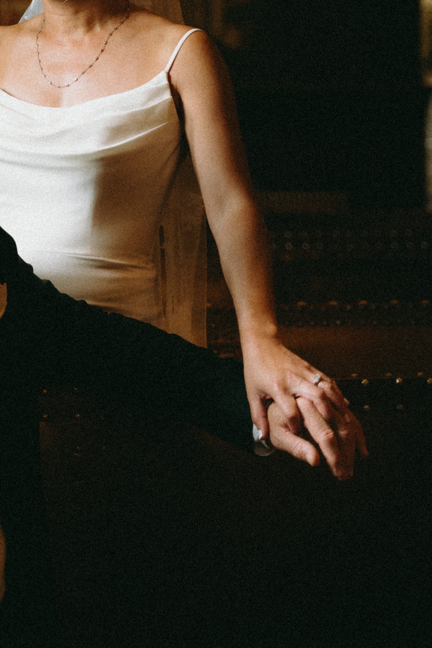 A close-up of the couple holding hands