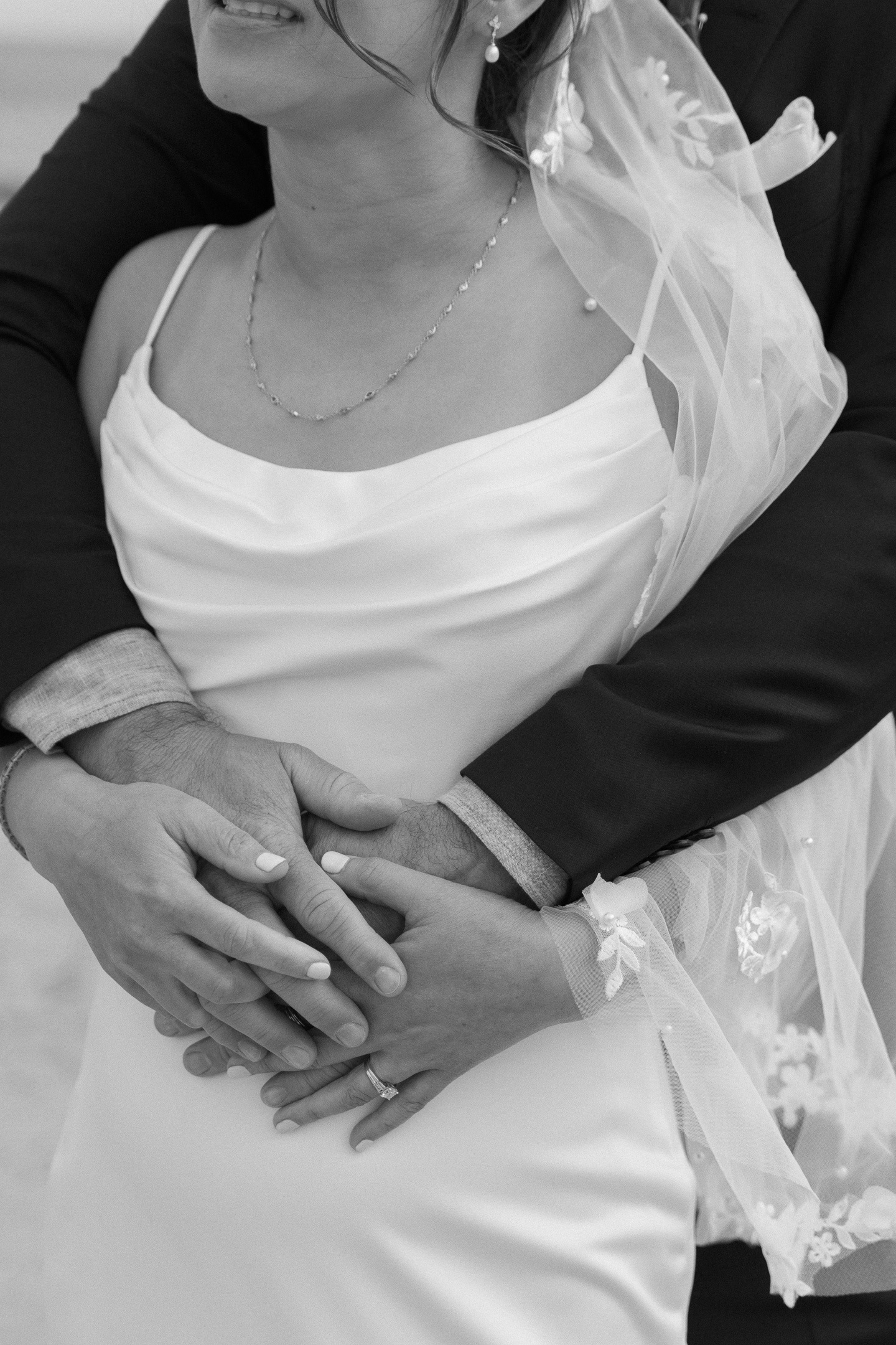 A black-and-white portrait of the couple embracing