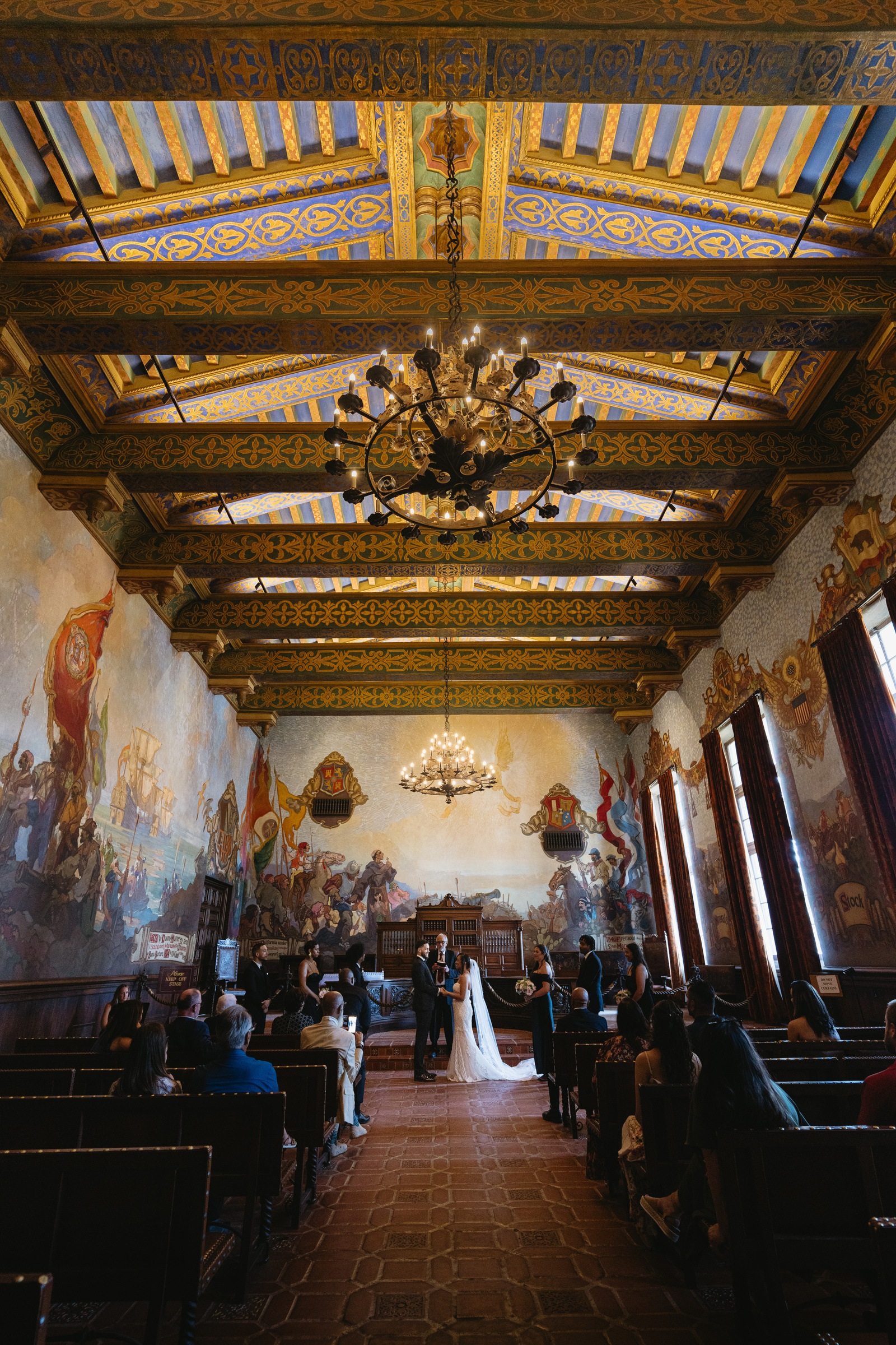 A wedding ceremony in the ornate mural room