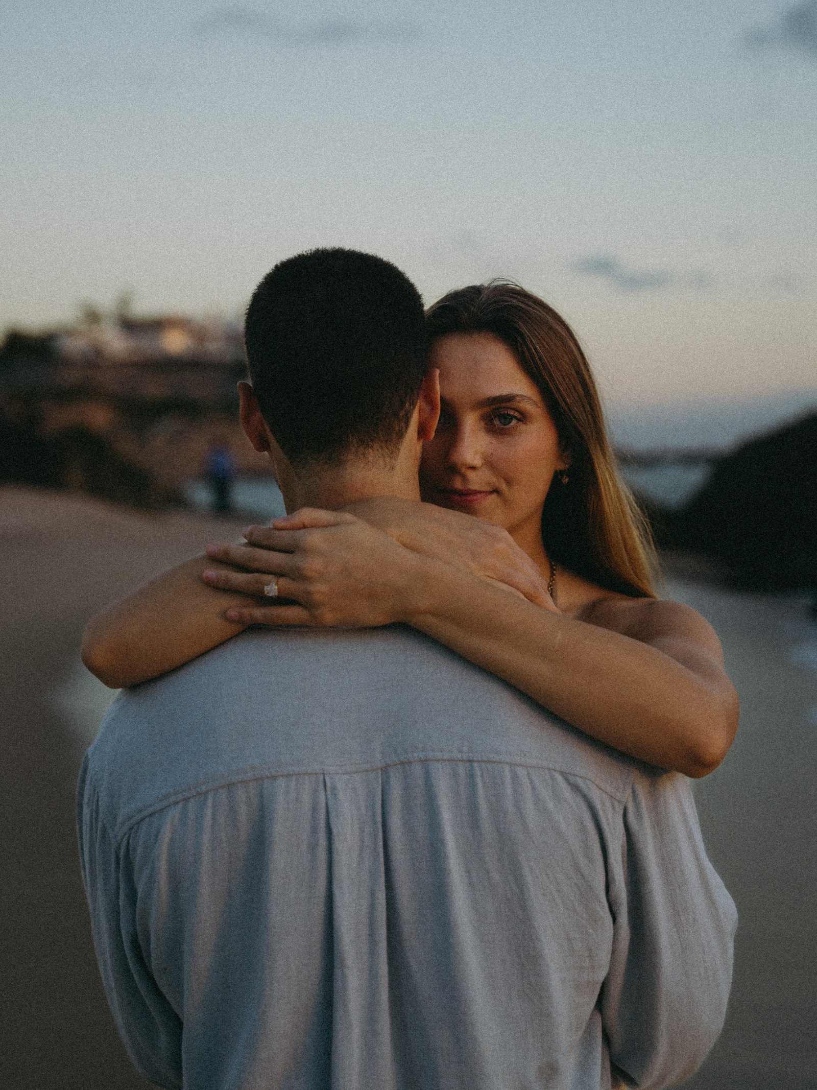 A quiet embrace on the beach at dusk