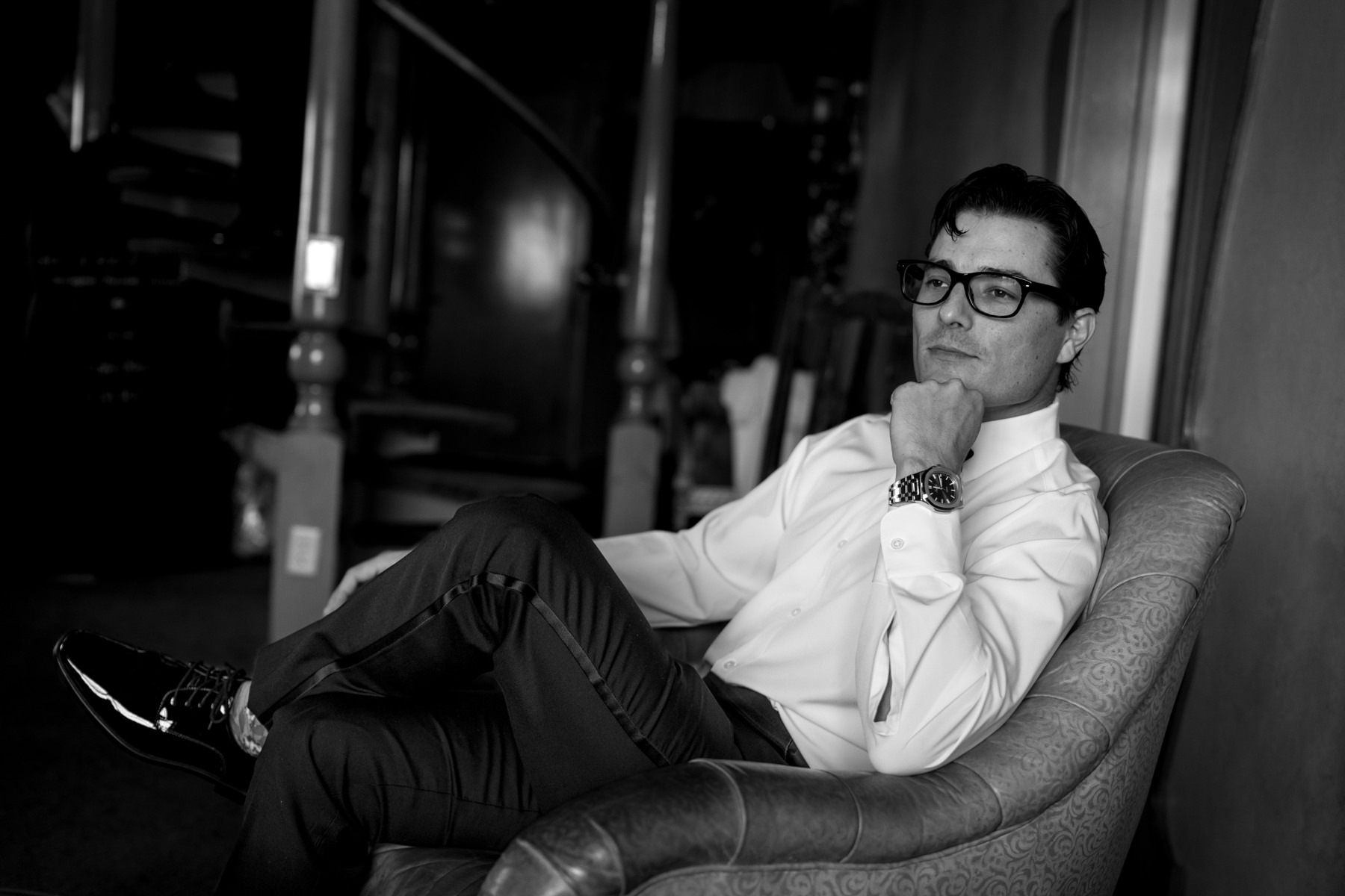 A black-and-white portrait of the groom