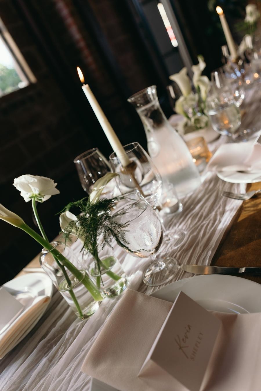 White roses and candles on the wedding table